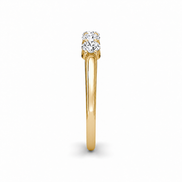 Just Brilliant Five Stone Diamond Band, Petite version with Round Brilliant diamonds in 18K yellow gold, side view. #jb-five-stone_petite_round-brilliant_18k-yellow-gold_side