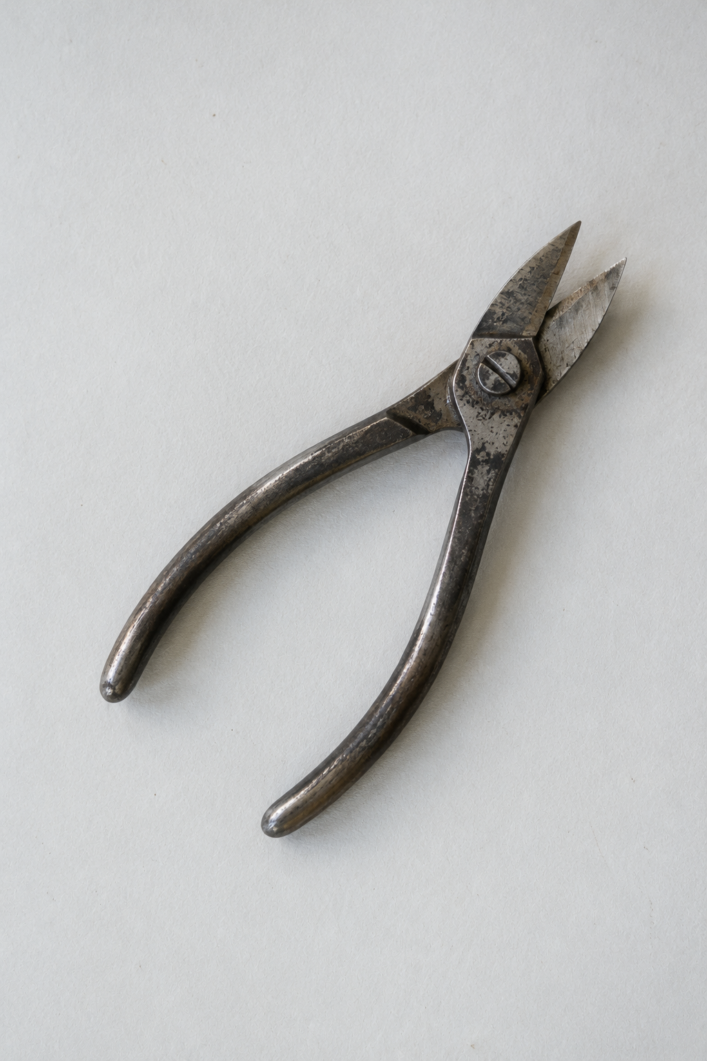 Original Just Brilliant craft study: worn steel goldsmith's shears on pale paper.