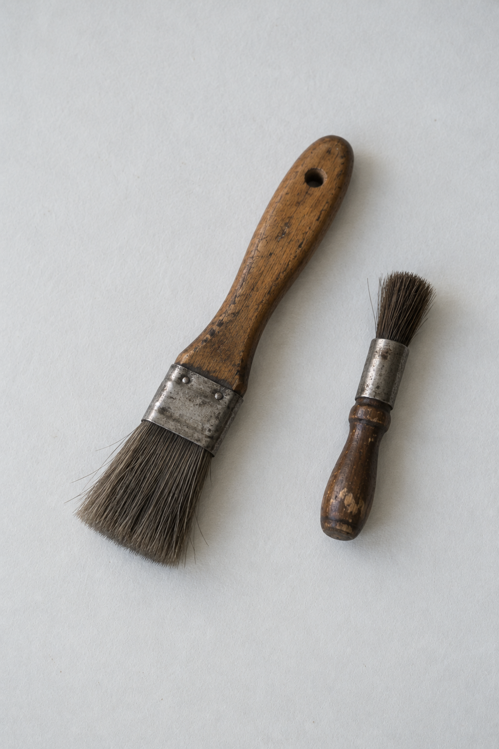 Original Just Brilliant craft study: two well-used workshop brushes on pale paper.