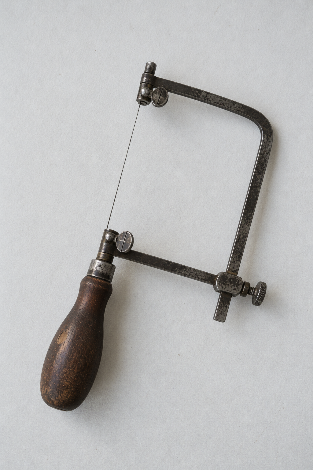 Original Just Brilliant craft study: a jeweler's piercing saw with a worn wooden handle.