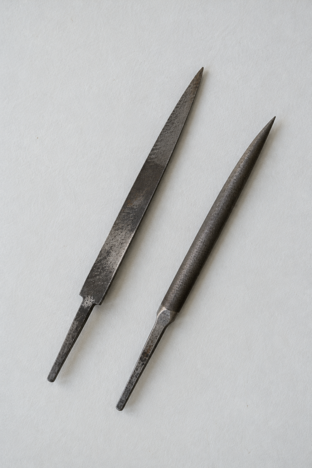 Original Just Brilliant craft study: two well-used steel files on pale paper.