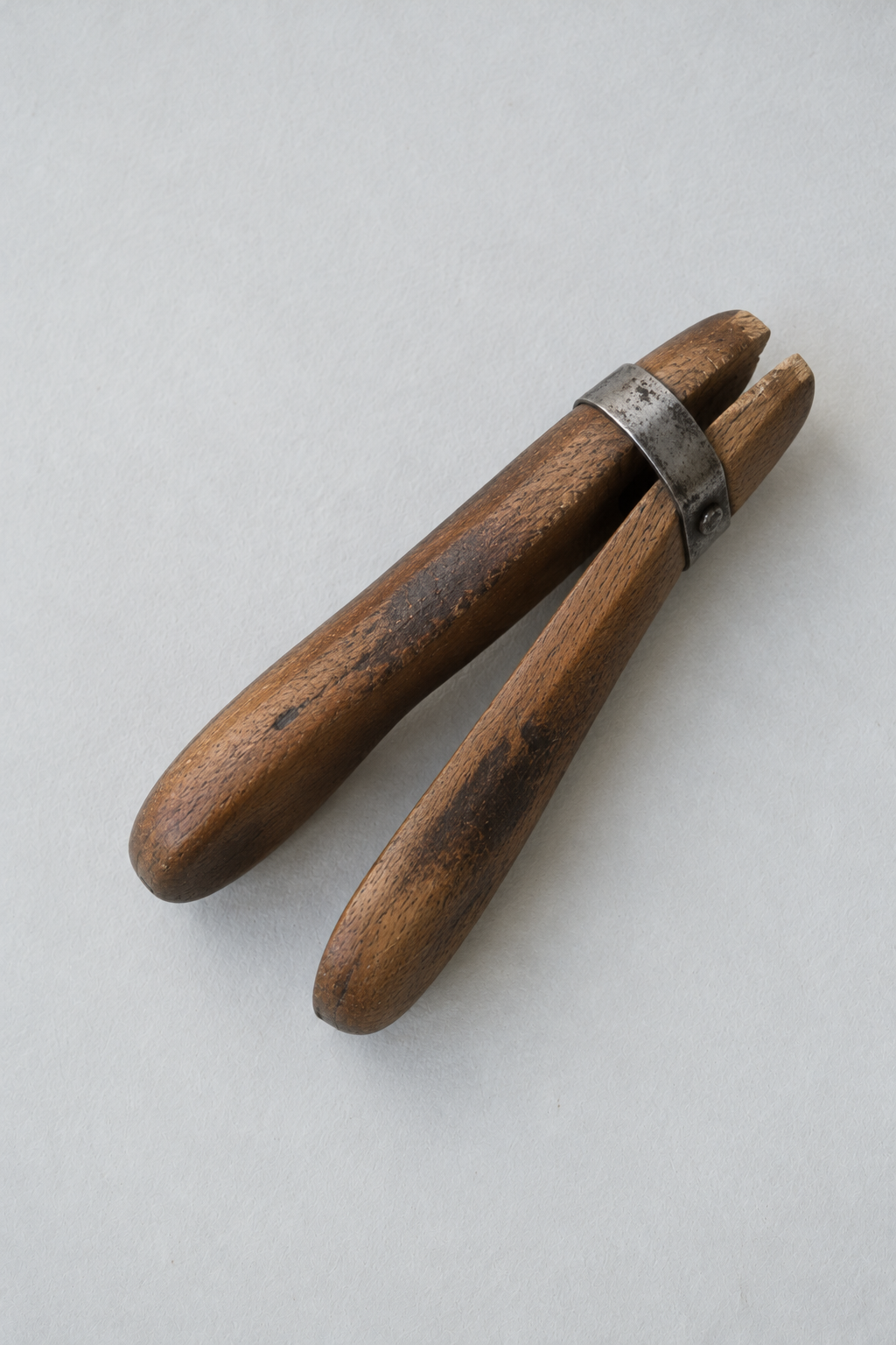 Original Just Brilliant craft study: a wooden jeweler's hand clamp with a steel band.