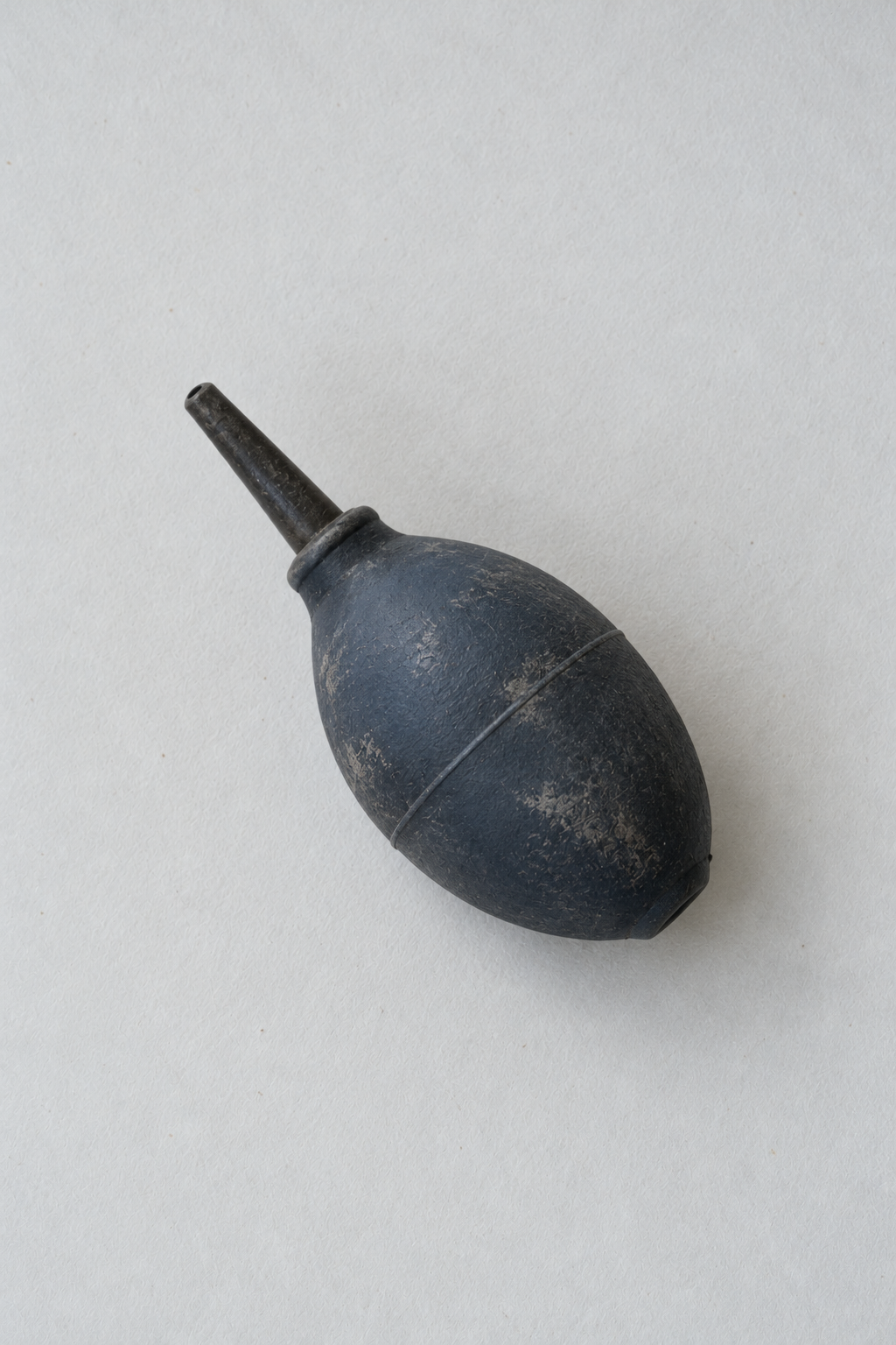 Original Just Brilliant craft study: a worn slate-blue rubber dust blower.