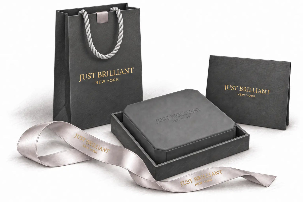 Pencil illustration of Just Brilliant’s charcoal shopping bag with silver rope handles, embossed clipped-corner jewelry case, gold-lettered certificate holder and branded satin ribbon.