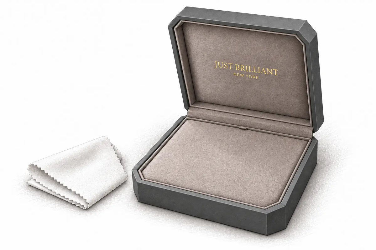 Pencil illustration of Just Brilliant’s open charcoal jewelry case with continuous suede lining beside a folded white polishing cloth.